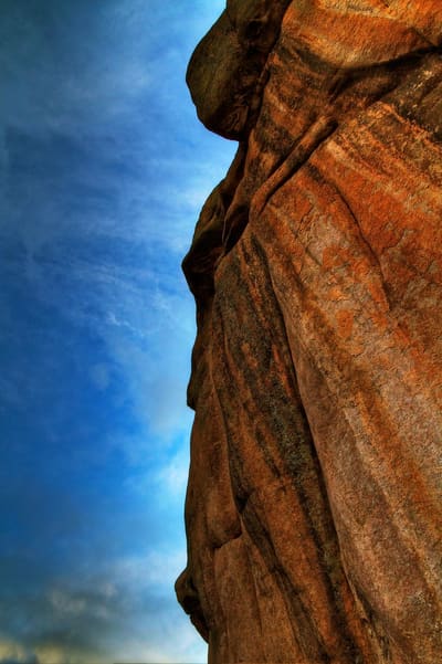 A red sandstone fin against a deep blue sky
