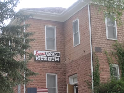 The rusticated red sandstone 1881 schoolhouse that houses the Lyons Redstone Museum