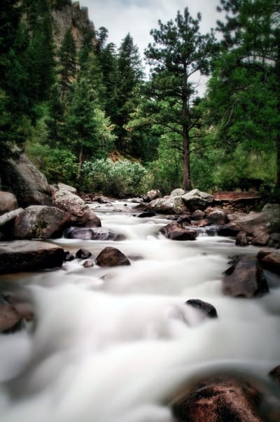 The North St. Vrain pouring white between red sandstone boulders in the canyon above Lyons